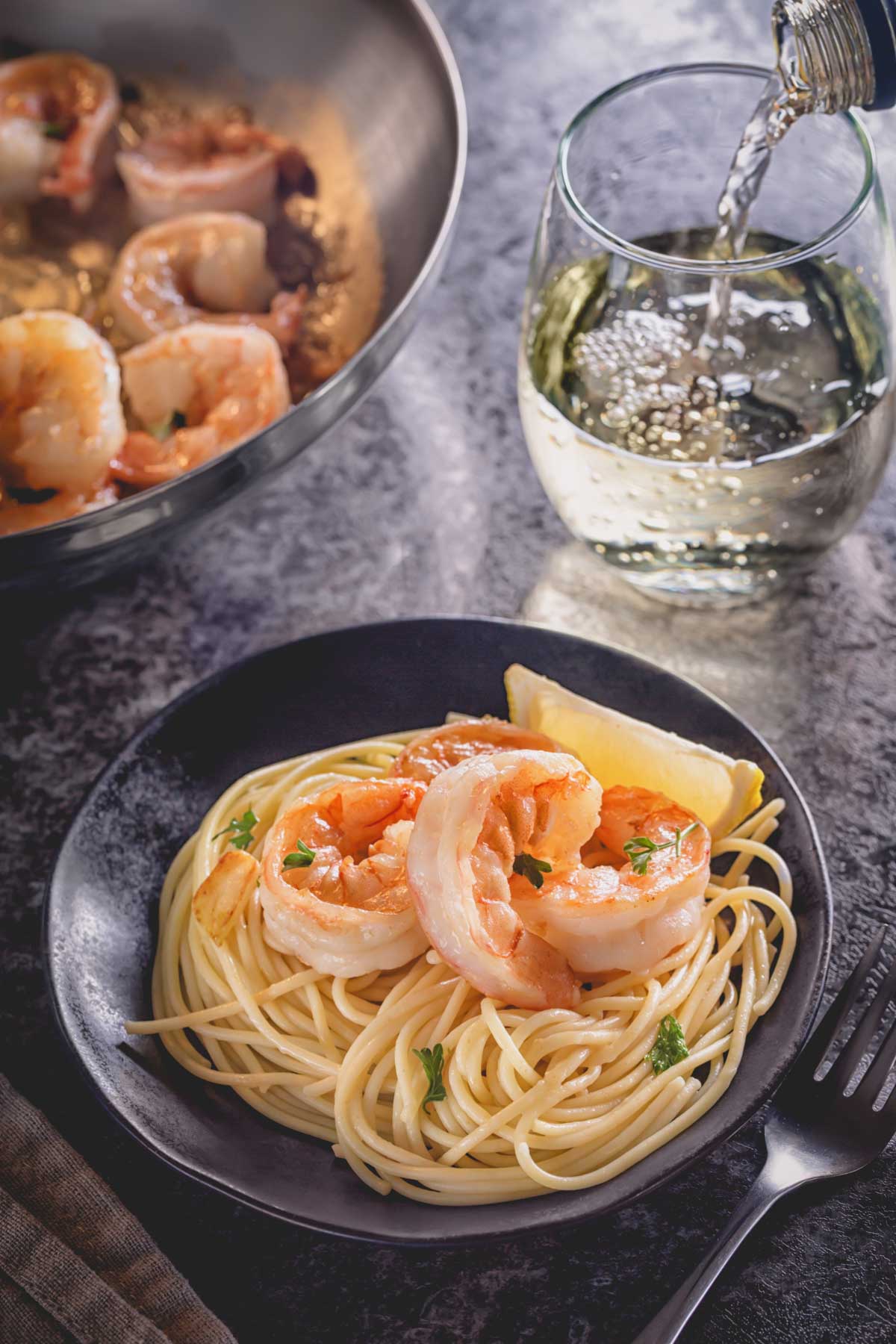 Cooked shrimp over a bed of spaghetti.