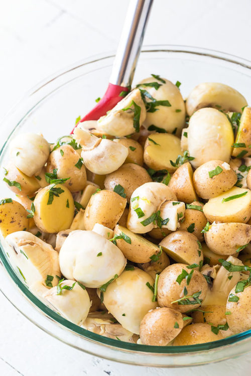 Super easy, yet seriously addicting, these grilled lemon & herb potatoes and mushrooms have bright, fresh and zesty flavor with a touch of smoky taste. Be warned: this quick and easy side dish may just become the star of the show on your next bbq cookout. #sidedish #grilledpotatoes #grilledmushrooms #grilling #bbqsidedish #lemonherbpotatoes #potatokebabs #mushroompotatoskewers