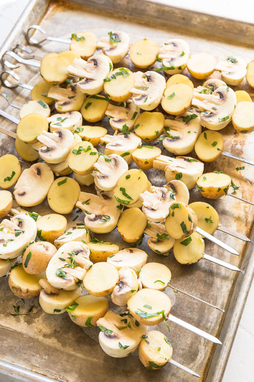 Super easy, yet seriously addicting, these grilled lemon & herb potatoes and mushrooms have bright, fresh and zesty flavor with a touch of smoky taste. Be warned: this quick and easy side dish may just become the star of the show on your next bbq cookout. #sidedish #grilledpotatoes #grilledmushrooms #grilling #bbqsidedish #lemonherbpotatoes #potatokebabs #mushroompotatoskewers