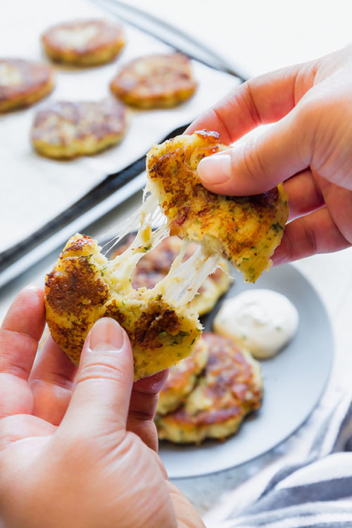 My kids LOVE these fluffy cheesy potato patties! Transform the leftover mashed potatoes into deliciously soft potato patties loaded with cheese, bacon and everything in between! #leftovermashedpotatoes #potatocakes #potatopatties #easydinner #sidedish #potatoes #busycooks