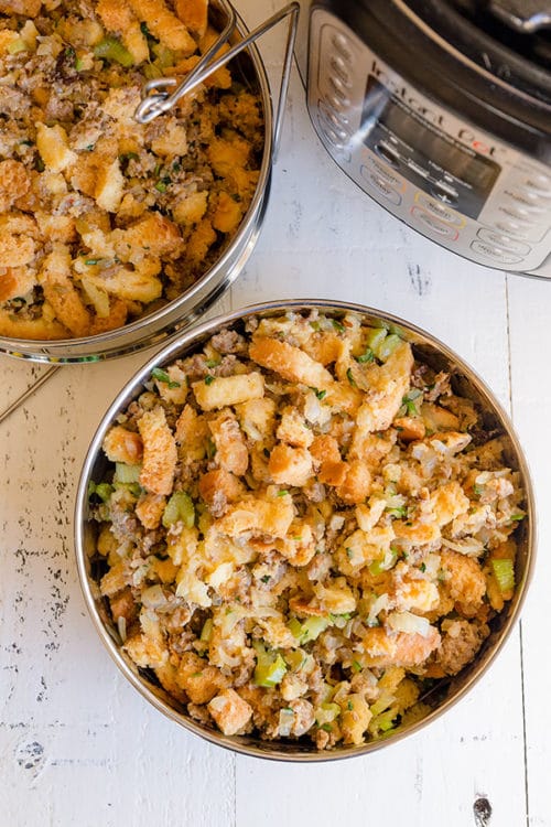 Final step in making Instant Pot Sausage Stuffing - divide the stuffing mixture into 2 stackable pans. #instantpotrecipes #instantpot #sausagestuffing #thanksgivingmenu #stuffing #potinpotcooking