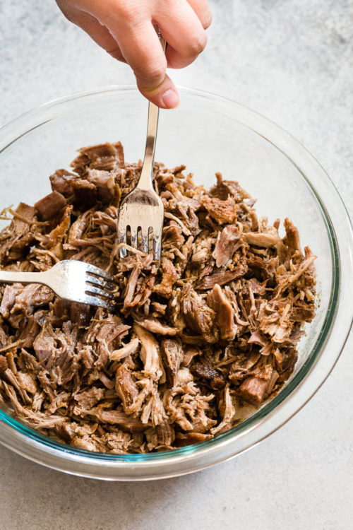 Instant Pot Pulled Pork - sharing my secrets to super tender and smoky pulled pork in 90 minutes! Plus, 9 side dish options and 5 ways to serve leftovers! #pulledpork #instantpotpulledpork