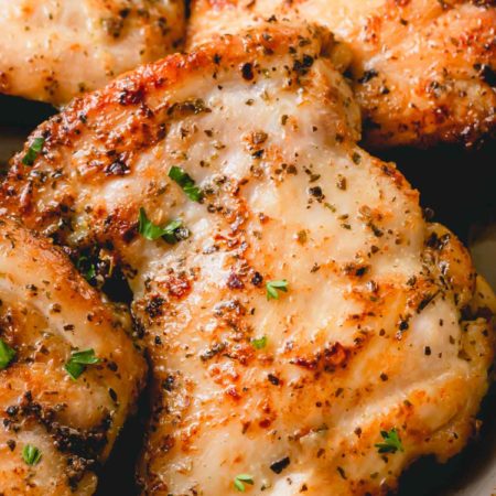Stovetop chicken thighs on a plate.