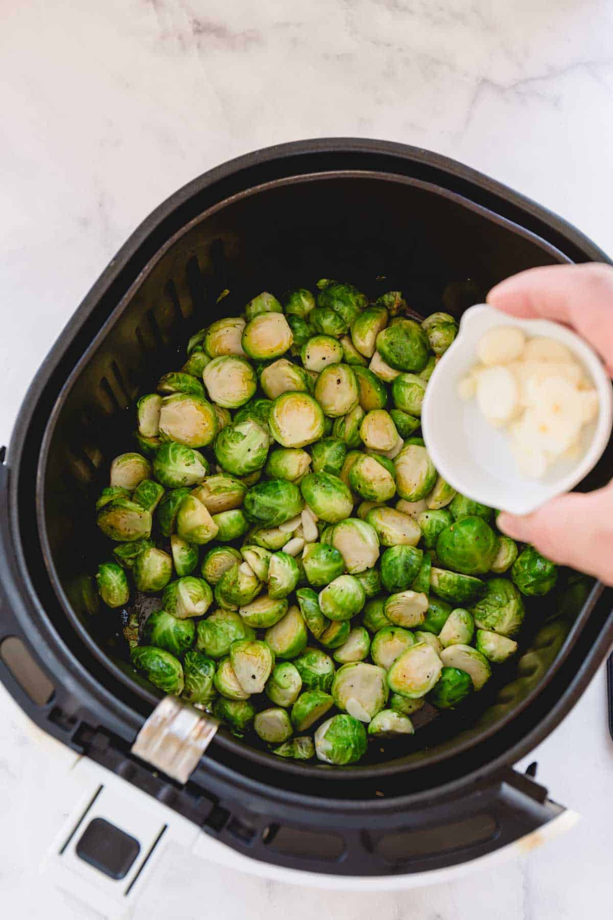 add garlic to the air fryer with brussels sprouts.