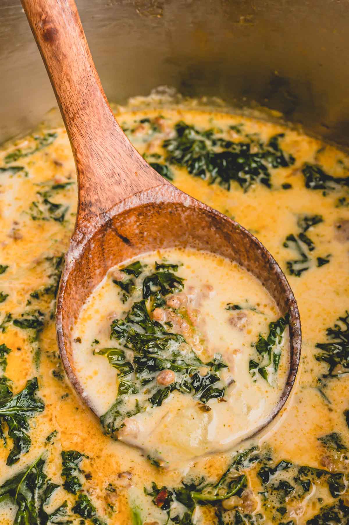 a large spoonful of zuppa toscana soup.
