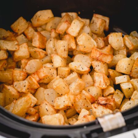 roasted potatoes in an air fryer basket.